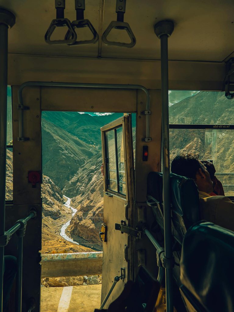Captivating view of mountains from a bus window, showcasing a winding river.